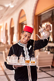 person pouring mint tea